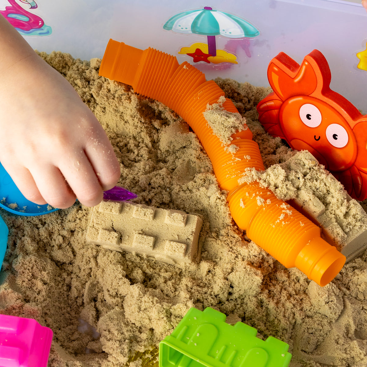 Hands-on Beach Sensory Bin play with mouldable sand and beach toys
