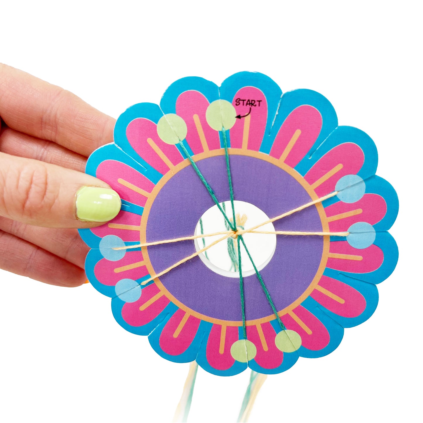 Hands using the included weaving tool to make a friendship bracelet