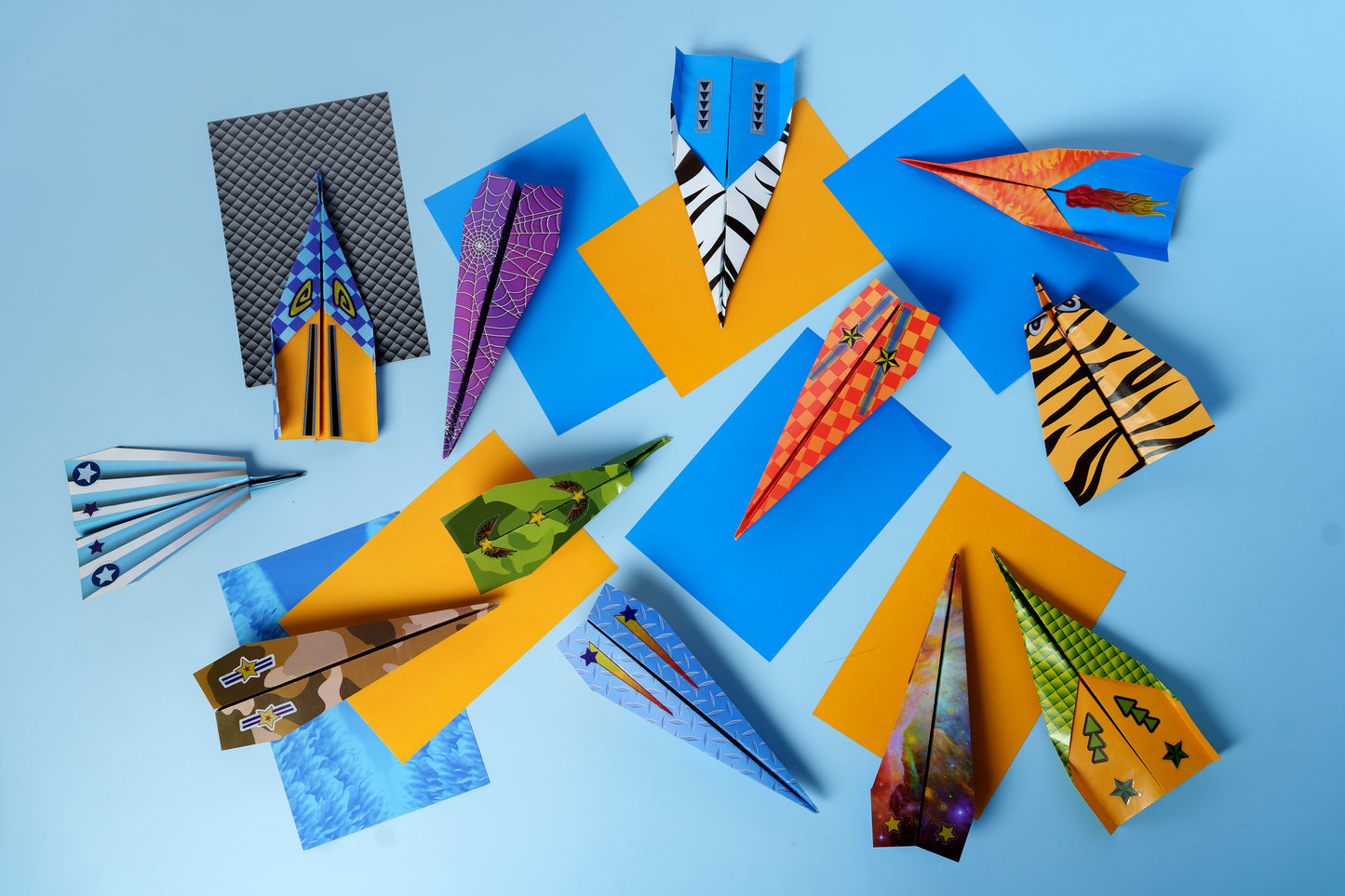 Collection of colourful finished paper airplanes made with the craft kit