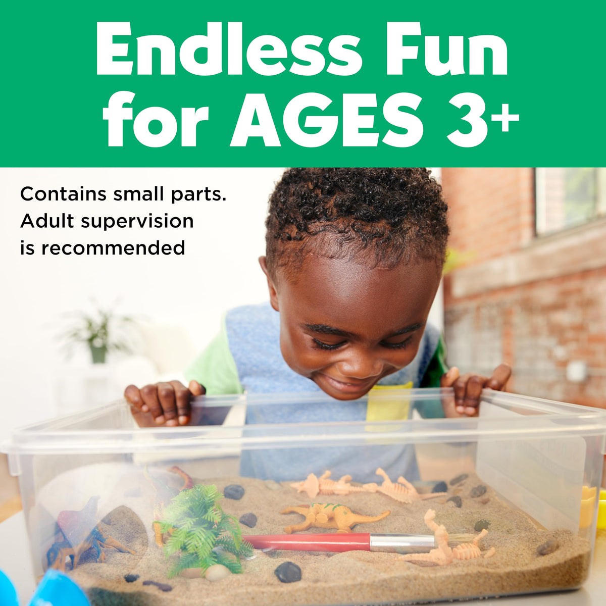 Child playing with the Dinosaur Sensory Bin, a sensory play activity for children ages 3 and over